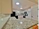 The updated kitchen features white cabinets, stainless steel appliances, and granite countertops at 133 Larson Dr, Summerville, SC 29485