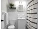 Clean bathroom with white tile and updated vanity at 1385 Fairfield Ave, Charleston, SC 29407