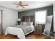 Serene bedroom with hardwood floors, an accent wall, and a full bed at 1385 Fairfield Ave, Charleston, SC 29407