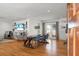 Bright dining room with hardwood floors, a large wooden table, and access to the living area at 1385 Fairfield Ave, Charleston, SC 29407