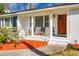 Inviting front porch with wood door and two armchairs, creating a welcoming entrance at 1385 Fairfield Ave, Charleston, SC 29407