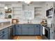 Modern kitchen with granite countertops, stainless steel appliances, and blue cabinets at 1385 Fairfield Ave, Charleston, SC 29407