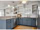 Modern kitchen with granite countertops, stainless steel appliances, and blue cabinets at 1385 Fairfield Ave, Charleston, SC 29407