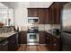 Modern kitchen with dark wood cabinets and granite counters at 1632 Telfair Way, Charleston, SC 29412