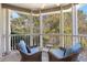 Relaxing screened porch with wicker chairs and wooded views at 1632 Telfair Way, Charleston, SC 29412