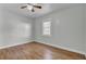 A bright bedroom features sleek hardwood floors, neutral walls, and a ceiling fan at 1904 Iris St, North Charleston, SC 29405