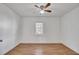 Simple bedroom features hardwood flooring, fresh paint and a single window at 1904 Iris St, North Charleston, SC 29405