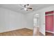 Cozy bedroom with wood floors, ceiling fan and open closet space at 1904 Iris St, North Charleston, SC 29405