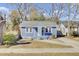 Charming blue home featuring a well-maintained yard and inviting front porch at 1904 Iris St, North Charleston, SC 29405