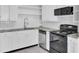Modern kitchen with stainless steel appliances and white cabinets at 1904 Iris St, North Charleston, SC 29405