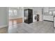 Open kitchen featuring appliances, gray tile, and view to dining room at 1904 Iris St, North Charleston, SC 29405