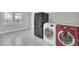 Functional laundry area with modern machines, tile floor, and natural light from nearby windows at 1904 Iris St, North Charleston, SC 29405