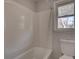 Bathroom with tub shower combo and window at 210 Drexel Rd, Ladson, SC 29456