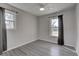 Bright bedroom with gray floors and two windows at 210 Drexel Rd, Ladson, SC 29456