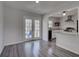 Dining area with hardwood floors, access to a deck, and open view to kitchen at 210 Drexel Rd, Ladson, SC 29456