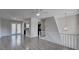 Open living room with hardwood floors, kitchen access and a view of the upper floor at 210 Drexel Rd, Ladson, SC 29456
