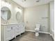 Bathroom featuring modern vanity, round mirrors, and chrome lighting at 213 Rose Ave, Walterboro, SC 29488