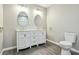 Bathroom with double vanity, round mirrors, and chrome fixtures at 213 Rose Ave, Walterboro, SC 29488