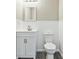 Half bathroom with modern white wainscoting, vanity, and gray vinyl flooring at 213 Rose Ave, Walterboro, SC 29488