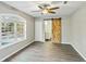 Bedroom with neutral paint, modern ceiling fan, and rustic barn door at 213 Rose Ave, Walterboro, SC 29488