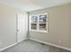 Bedroom boasts modern flooring, light-filled window, and neutral colored walls at 213 Rose Ave, Walterboro, SC 29488