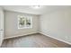 This bedroom has neutral walls, modern flooring, and a large window with natural light at 213 Rose Ave, Walterboro, SC 29488