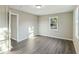 Bedroom with neutral paint, gray vinyl floors, and a view of the neighborhood at 213 Rose Ave, Walterboro, SC 29488
