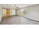 Light-filled bedroom with en-suite bathroom, barn door, wood-look flooring, and large window at 213 Rose Ave, Walterboro, SC 29488