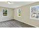 Bedroom with neutral walls, gray vinyl floors, and bright natural light at 213 Rose Ave, Walterboro, SC 29488
