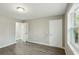 Bedroom with light gray walls, neutral flooring, and access to closet and hallway at 213 Rose Ave, Walterboro, SC 29488