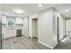 Updated kitchen with stainless steel appliances and stone countertops, and gray flooring at 213 Rose Ave, Walterboro, SC 29488