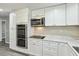 Bright kitchen boasts white cabinetry, stainless steel appliances, and stone countertops at 213 Rose Ave, Walterboro, SC 29488
