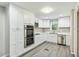Bright, modern kitchen with stainless steel appliances and white cabinetry at 213 Rose Ave, Walterboro, SC 29488