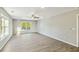 Bright living room with hardwood floors, large windows, and a ceiling fan at 213 Rose Ave, Walterboro, SC 29488