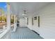 Inviting covered porch featuring white railing and a ceiling fan at 213 Rose Ave, Walterboro, SC 29488