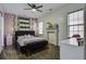 Bright bedroom with a ceiling fan and a decorative fireplace and large windows at 221 Trillium Ave, Summerville, SC 29483