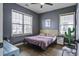 Comfortable bedroom with two windows, hardwood floors, neutral paint, and a decorative cactus at 221 Trillium Ave, Summerville, SC 29483