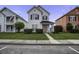 A two-story home with tidy lawn and sidewalk; surrounded by other colorful homes at 221 Trillium Ave, Summerville, SC 29483