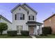 Charming two-story home with a well-maintained lawn and inviting front porch and beautiful pink front door at 221 Trillium Ave, Summerville, SC 29483