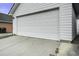 Attached garage featuring a white carriage door and concrete driveway at 221 Trillium Ave, Summerville, SC 29483