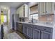 Modern kitchen featuring gray and white cabinets, stainless steel appliances, and ample natural light at 221 Trillium Ave, Summerville, SC 29483