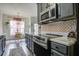Well-equipped kitchen with stainless steel appliances, sleek countertops, a decorative backsplash, and an adjacent dining area at 221 Trillium Ave, Summerville, SC 29483