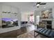 Open-concept living room with a fireplace, modern furniture, and a view into the kitchen and dining area at 221 Trillium Ave, Summerville, SC 29483