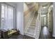 Bright staircase featuring hardwood floors, white risers, a geometric accent wall, and a sunlit window at 221 Trillium Ave, Summerville, SC 29483