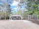 Backyard featuring a carport and surrounding landscape at 227 Bailey St, Walterboro, SC 29488