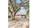 Cozy brick home with a light blue front door set amidst a yard shaded by a large, mature tree at 227 Bailey St, Walterboro, SC 29488