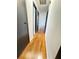 Hallway featuring hardwood floors connecting the living spaces at 227 Bailey St, Walterboro, SC 29488