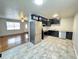 Modern kitchen with stainless steel appliances, sleek black cabinetry, and light-colored flooring at 227 Bailey St, Walterboro, SC 29488