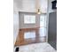 View of the open layout from the kitchen into a living space featuring hardwood floors and a large window at 227 Bailey St, Walterboro, SC 29488
