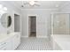 Bathroom with double vanity, walk-in closet, and patterned tile floor at 2517 Charter Oaks Dr, Mount Pleasant, SC 29466